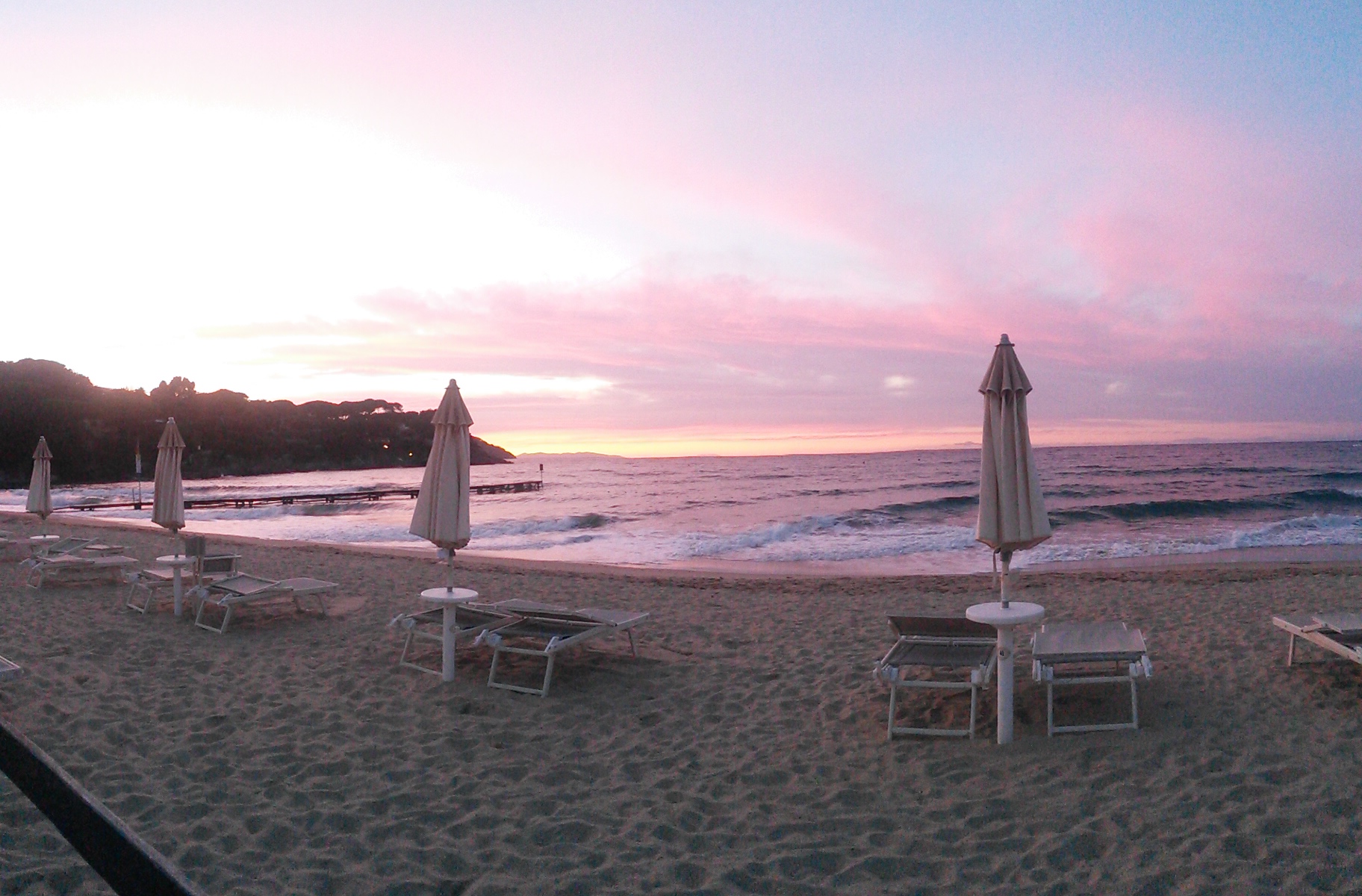 Spiaggia procchio rosa arancione cielo mare ombrelloni relax 